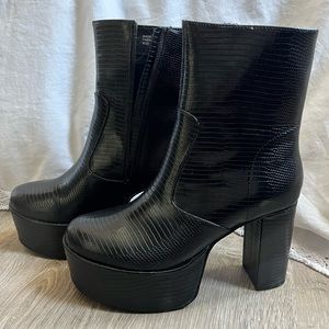 Black zipper high platform boots.